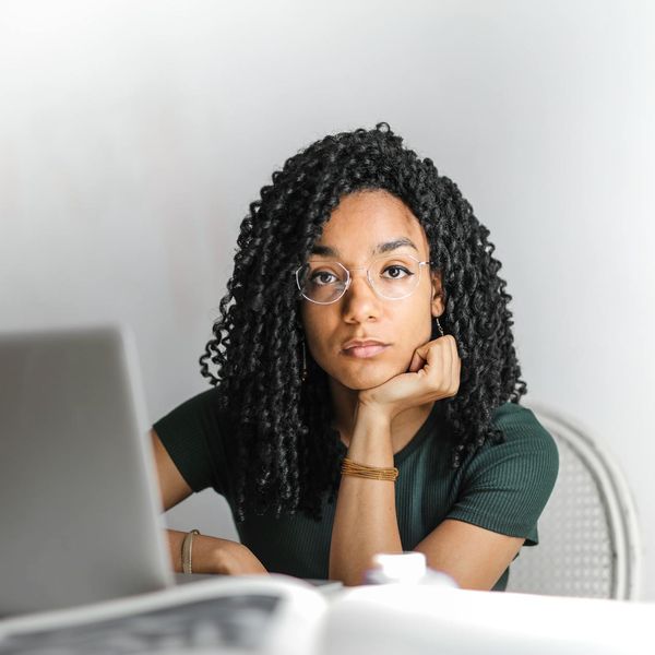 Office worker looking focused and calm in a modern workplace setting.
